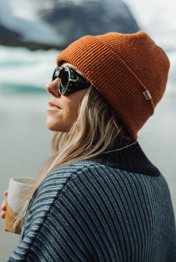 An aerial view of waves crashing against a shore.