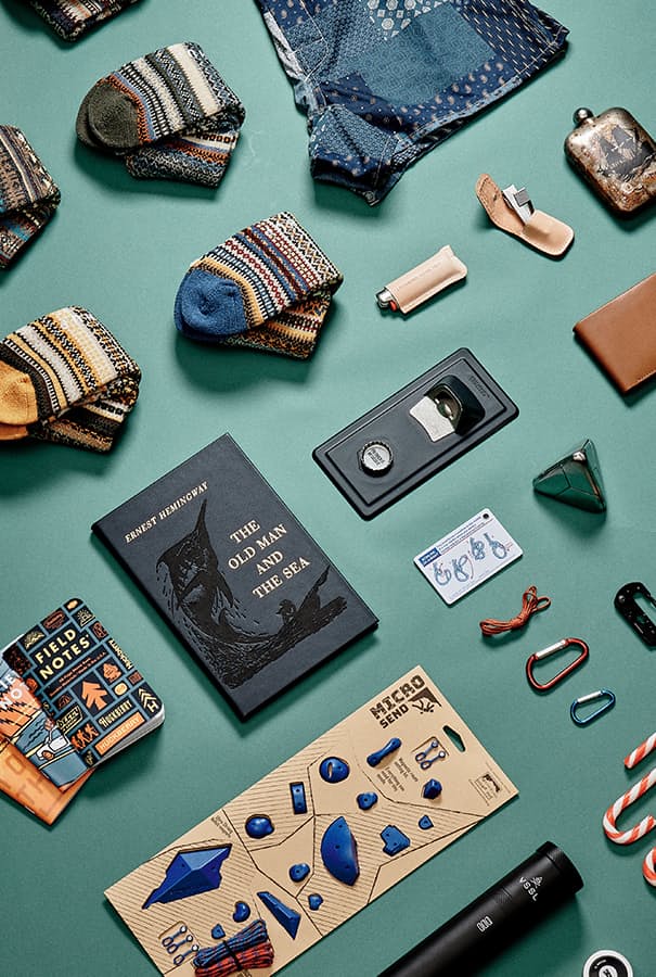 Image of stocking stuffers including notebooks, books, socks, knot booklet, and more