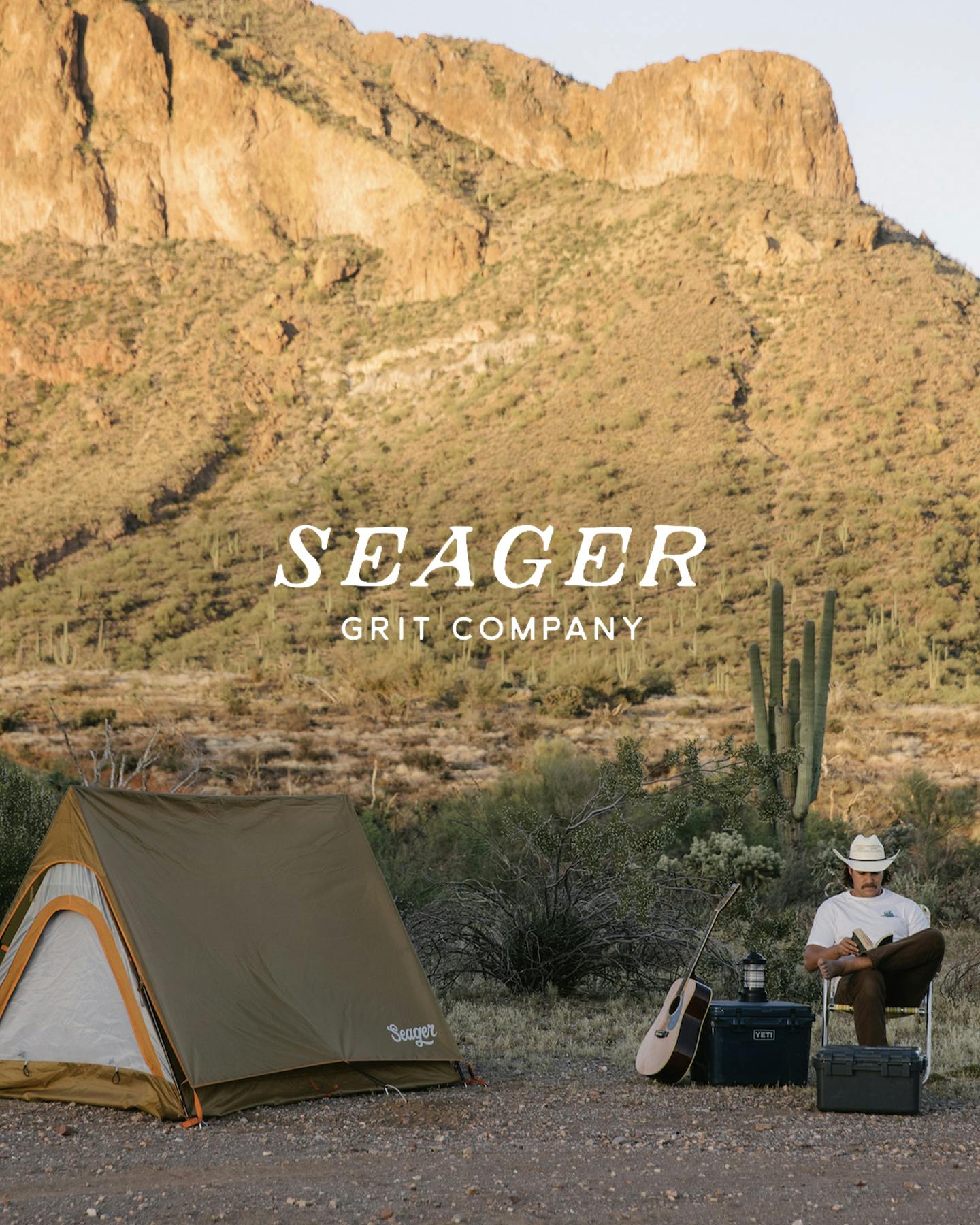 Man sitting in chair outdoors with Seager camping tent